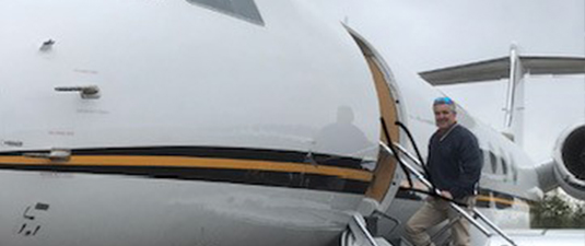 Man standing on stairs of an airplane at the Hazleton Airport