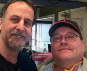 Two men standing together in the airport